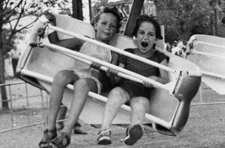 Two girls on a ride at the county fair, 1979