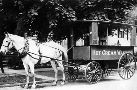  	John Comella sells waffles from horse-drawn wagon