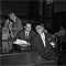 Sam Sheppard sits with his lawyers in the courtroom