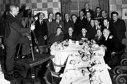 Harold Burton taking photograph of a group of photojournalists