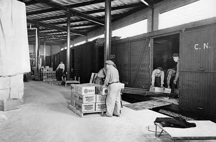 Workers load BPS paints into train car at Patterson-Sargent plant on Hamilton Ave., 1946